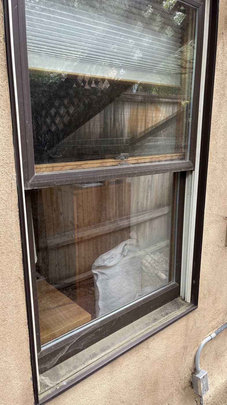 Dirty window with grime and streaks before cleaning